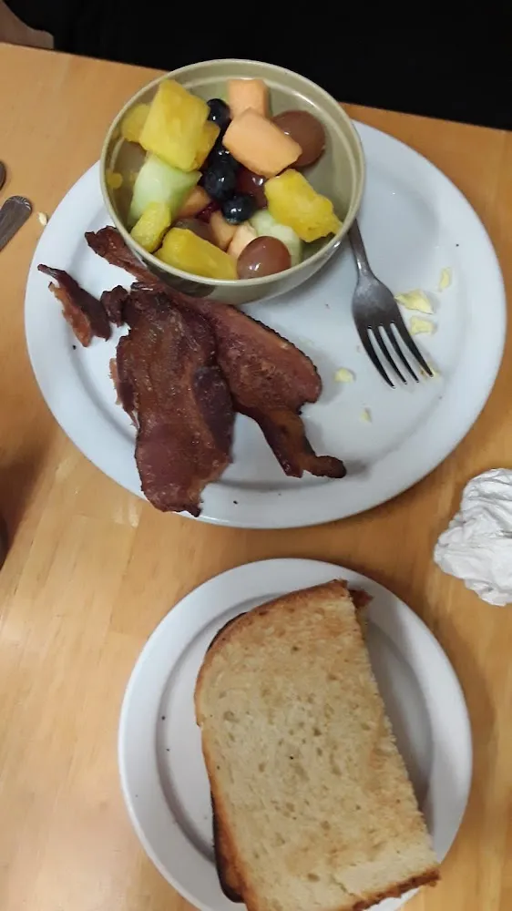 Too Hard Scrambled Eggs with Bacon and Side of Fresh Fruit